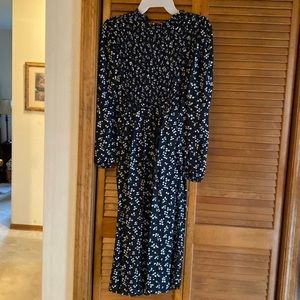 Black with white with small flowers. Long dress with long sleeves.